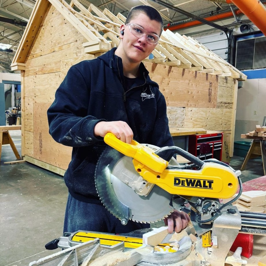 Building trades student works in the shop