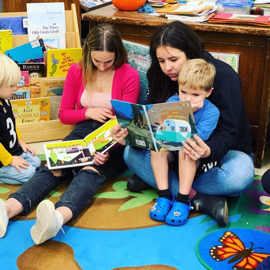 Children reading with ECE students