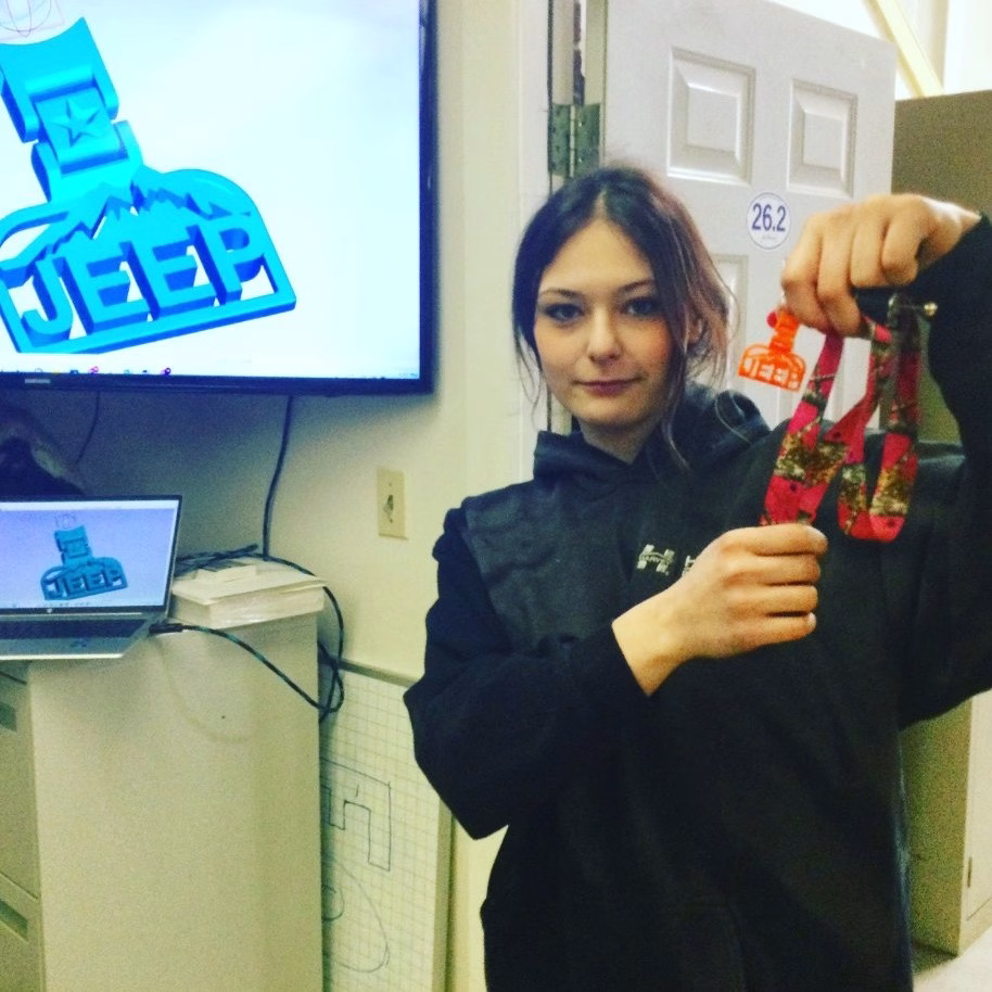 A female foundations student shows the work she did using the Aspire software