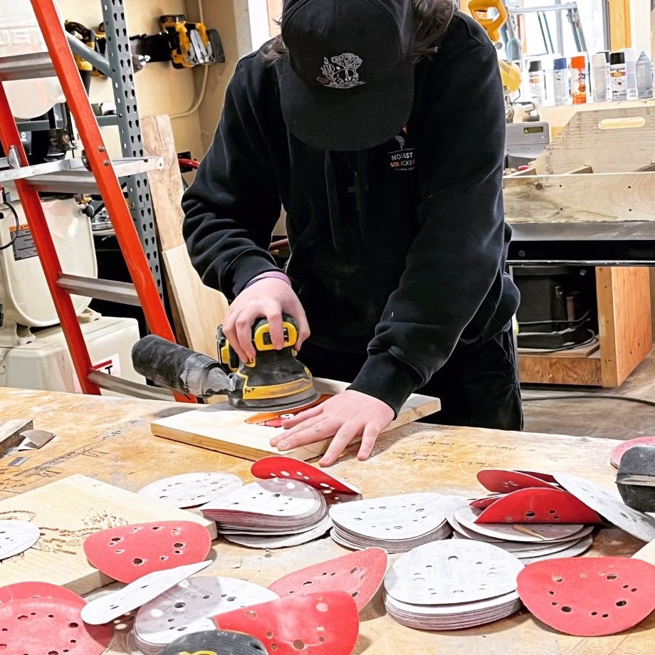 Foundations students sanding a project