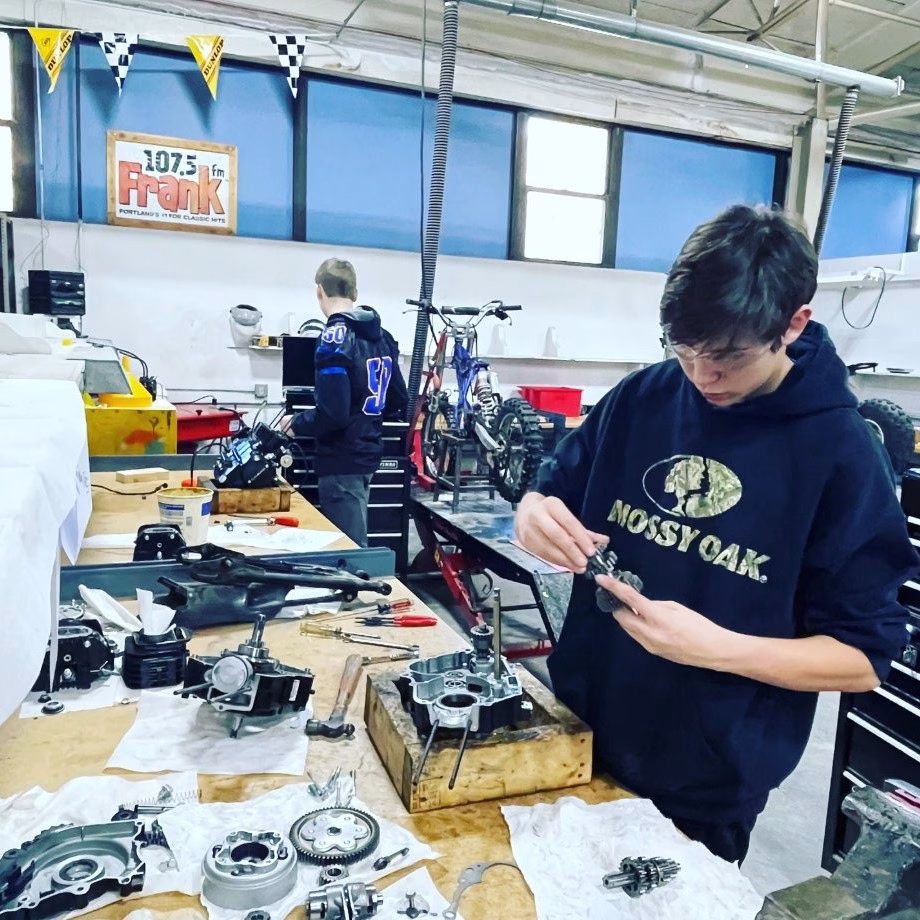 Students work on small motors in shop